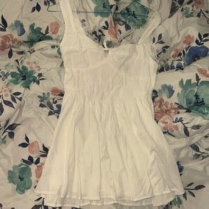 white mini dress with front tie and lace lined straps